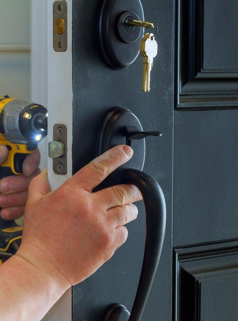 closeup-of-a-professional-locksmith-installing-a-new-lock-on-a-house-exterior-door-with-the-inside.jpg